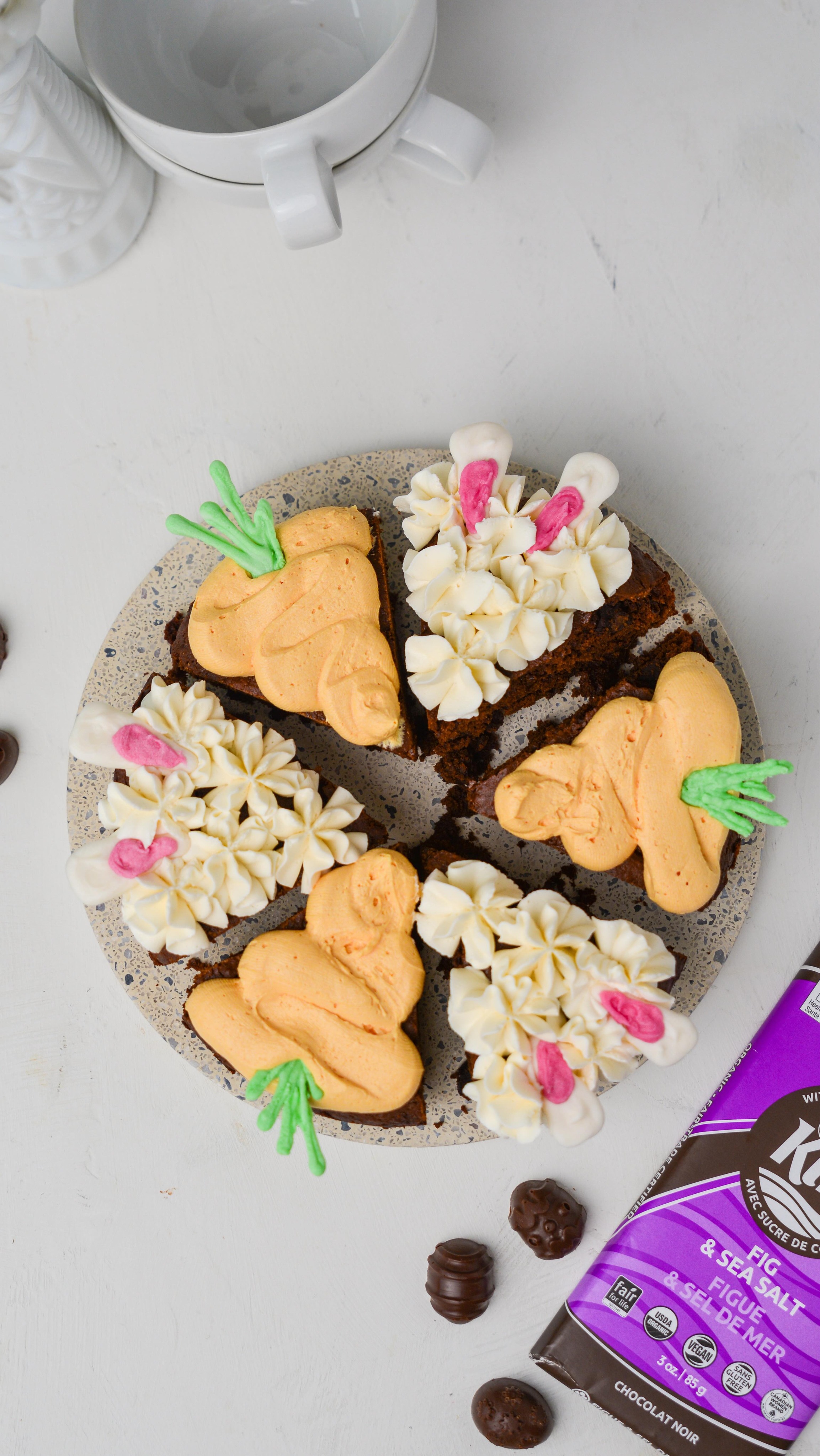 Celebrate Easter with these cute bunny and carrot brownies, made with @Zazubean KIKI bar 🍫🐰🥕 The fig and sea salt from the KIKI bar adds a nice touch of flavour to any classic brownie recipe 

Makes: 5 inch brownie

Ingredients:
For the toppings: 
* ½ cup vegan white chocolate chips
* Green and pink food colouring 

For the brownies:
* 2 tbsp flax meal + ¼ cup warm water = flax egg
* ¼ cup unsalted vegan butter
* ½ cup granulated sugar
* ¼ cup coconut sugar 
* ¼ cup non-dairy milk
* ½ cup all purpose flour
* ½ cup cocoa powder
* ½ tsp baking powder
* 1 KIKI bar, roughly chopped

For the frosting (or use 1 cup store bought):
* ¼ cup unsalted vegan butter, softened to room temperature
* 1 ½ cup icing sugar
* ½ tsp vanilla extract 
* 1 tbsp coconut cream
* Orange (or red + yellow) food colouring

Directions:
1. Make the toppings: melt the white chocolate, divide into 2 bigger and l smaller portions, and mix 1 big portion with green and 1 small portion with pink. Transfer to piping bags. On a flat tray lined with parchment paper, pipe green carrot leaves and white/pink bunny ears. Place in fridge to harden.
2. Preheat the oven to 350ºF and lightly oil a 5 inch can pan or line with parchment paper.
3. Melt the butter with half of the roughly chopped KIKI bar.
4. Measure the sugars into a large bowl and whisk together with the chocolate and butter mixture, flax egg, vanilla extract, and non-dairy milk.
5. Sift in flour, cocoa powder, baking powder, and salt. Half mix the batter together, add remaining chopped KIKI bar, and fold batter until there are no more traces of flour. 
6. Bake for 40-45 minutes. The center will be very moist but will firm up once cooled.
7. Allow brownie to sit in pan for at least 20 mins before transferring to a cooling rack. 
8. Make the frosting: beat the butter, icing sugar, vanilla, and coconut cream until smooth. Mix half of the frosting with orange food colouring.
9. Once the brownie is completely cooled, cut into 6 slices. Pipe 3pcs with white frosting and 3pcs with orange frosting. Top with carrot leaves and bunny ears.

-LL🤍
#Zazubean #eastertreats #easterdesserts #bestofveganbaking #brownies